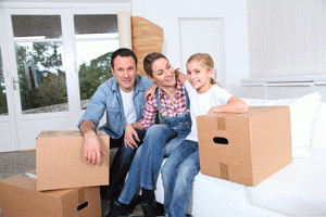 Family with moving boxes inside home